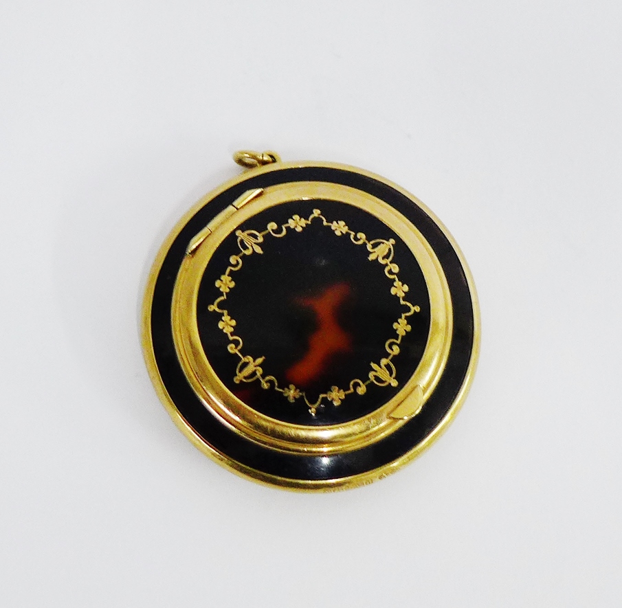 An early 20th century 9 carat gold and tortoiseshell powder compact, the hinged lid with pique