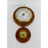 An oak circular wall barometer and another smaller, (2)