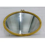 An oval gilt framed wall mirror with a bevelled plate, 85 x 60cm