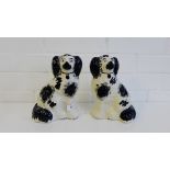 A pair of black and white glazed Staffordshire chimney spaniels, 21cm high, (2)