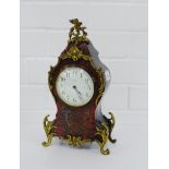 A tortoiseshell and boulle mantle clock with brass mounts and enamel dial inscribed Edward