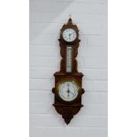 A carved oak wall clock and barometer, 72cm