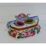 A Scottish Pottery Wemyss style inkwell painted with cabbage roses and dolphin surmounts, it has