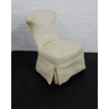 A cream upholstered bedroom chair