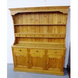 A pine Welsh style dresser with a shelved plate back and row of seven short drawers over three