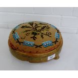 A circular foot stool with wool work and bead work top