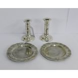 A pair of Edwardian silver dwarf candlesticks with harebell and garland repousee decoration,
