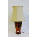 A pottery table lamp base painted with abstract fruit and flowers