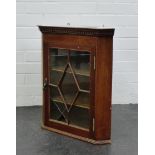 A mahogany corner cupboard of small proportions, with astragal glazed door, 56 x 44cm