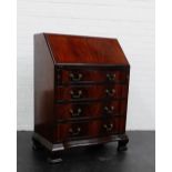 A mahogany bureau, the fall front over pull out slides and four long drawers, 105 x 77cm