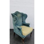 An upholstered wing armchair, 114 x 72cm