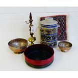 A mixed lot to include West German jar and cover, two Eastern coppered tin bowls and a small mat,