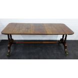 An oak table, the rectangular top with rounded edges, raised on twin ring turned supports, with