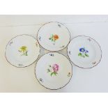 A set of four Meissen brown edged and white glazed plates painted with floral sprays (with rim