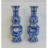 A pair of blue and white archaic style vases painted with figures, horses, birds and precious