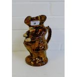 A copper lustre Toby jug of the 'Snuff Taker', 21cm high