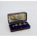 A 12 stone diamond flowerhead brooch set on an unmarked yellow gold bar, boxed 6cm long