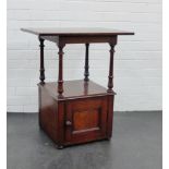 A mahogany bedside cabinet, the square top on turned supports above a cupboard to the base, 72 x