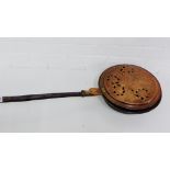 A copper bed warming pan with turned wood handle