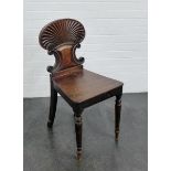 A mahogany shell back hall chair, with solid seat and turned tapering supports
