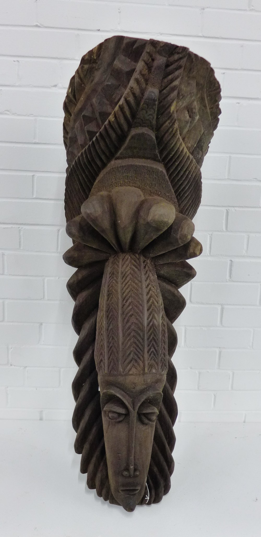 A large African carved figure head, 110cm long
