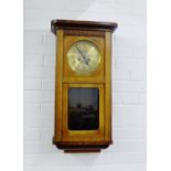 An oak cased wall clock, 76 x 140cm