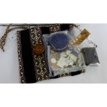 A velvet and wool tapestry bag containing a collection of vintage buttons and mother of pearl tokens