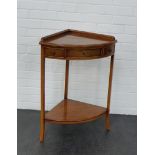 A cherry wood corner table with one central frieze drawer flanked by two dummy drawers on splayed