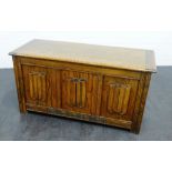 An oak trunk with panelled front, the lift up top opening to reveal plain interior, 54 x 106cm