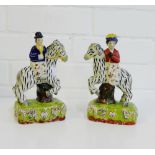 A pair of reproduction Staffordshire black and white horse and rider figures, 19cm high, (2)