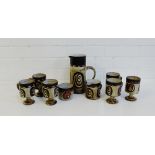 A Studio pottery coffee set comprising eight cups, cream jug, sugar bowl and a tall jug, (a lot)