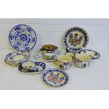 A collection of Quimper French pottery to include plates, dishes, bowls, mugs, etc., (15)