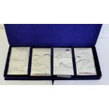 Four Italian silver and wood wall plaques, depicting landscape patterns, in a fitted box (4)