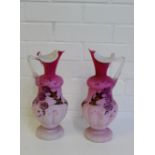 A pair of pink satin glass ewer's painted with Birds and Flowers on circular foot rims, 31cm