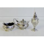 Silver three piece condiment set comprising mustard, salt and pepper pot, with blue glass liners,
