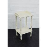 A white painted two tier side table on baluster supports, 68 x 36cm