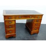 A mahogany desk, the rectangular top green leather insert, with one central frieze drawer flanked by