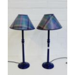 A pair of blue painted wooden table lamp bases with tartan shades, (2)