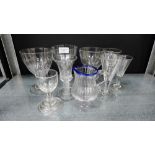 A collection of Georgian and later drinking glasses, together with a blue rimmed glass jug and two