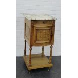 A French style marble topped bedside cabinet with one frieze drawer above a cupboard door on