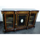 A Victorian ebonised and walnut credenza, the breakfront top over a central cupboard door with an