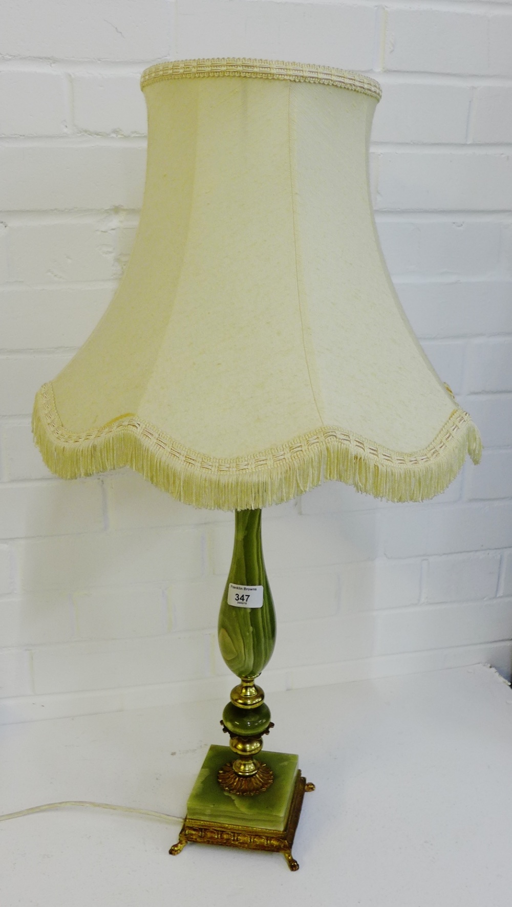 An onyx and brass mounted table lamp and shade