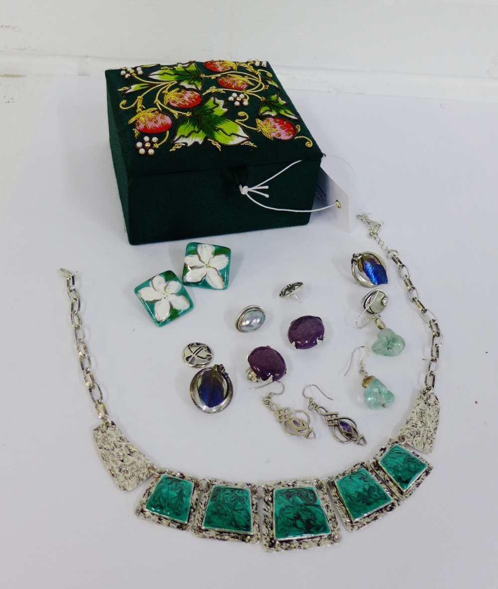 An embroidered box containing a selection of modern silver earrings and a costume jewellery