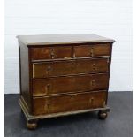 An oak chest of drawers, the rectangular top over two short and three long drawers, on bun feet,