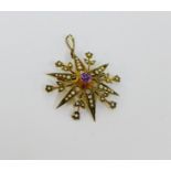 An early 20th century 9 carat gold star burst brooch / pendant, set with amethyst and seed pearls,