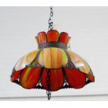 An opaque orange glass panelled ceiling light with bronzed metal mounts in the Tiffany manner