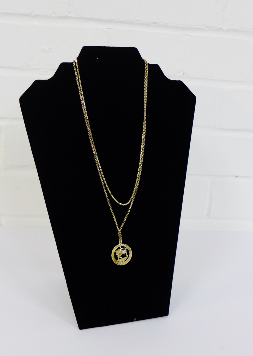 9 carat gold Taurus circular pendant on a 9 carat gold chain together with a 9 carat gold box