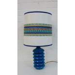 A retro turquoise hard plastic table lamp base and shade