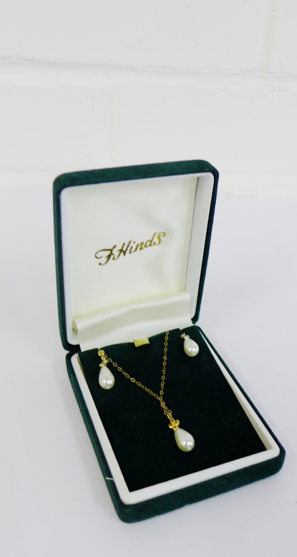 Faux pearl pendant and earrings set on a 9 carat gold chain