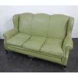 A light green leather upholstered sofa on carved claw and ball feet, 104 x 166cm